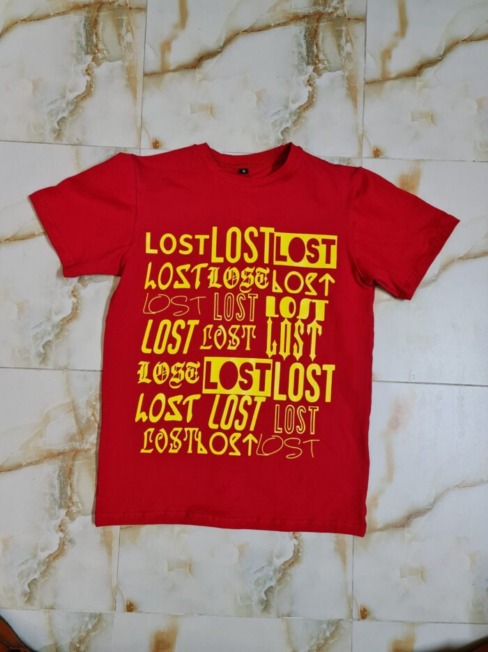 A trendy red t-shirt laid flat, showcasing its soft fabric and stylish design, ideal for casual wear.